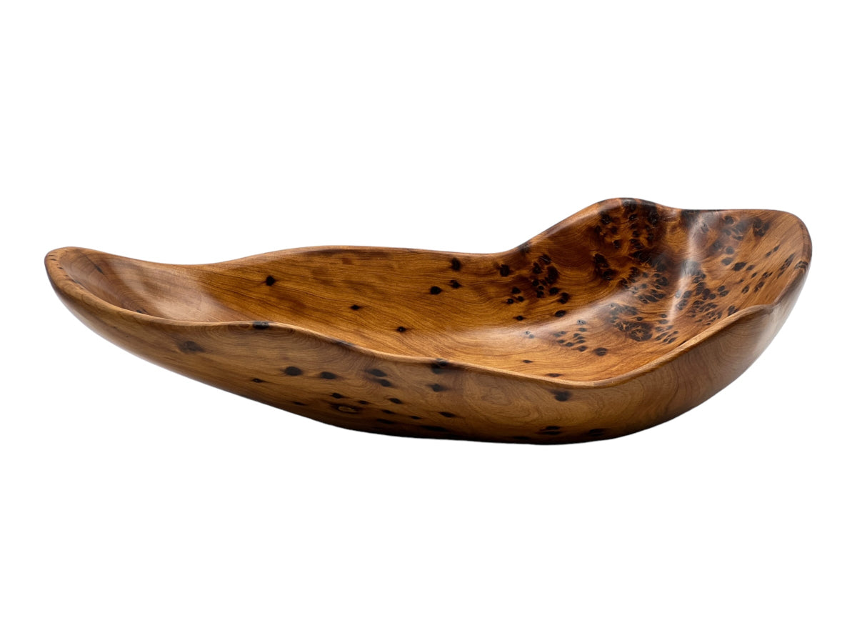 A polished wooden floka plate with natural wood patterns.