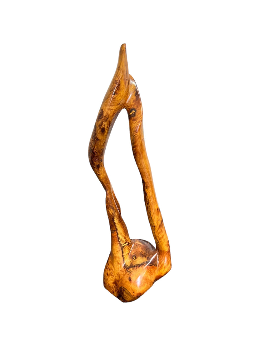 A wooden sculpture resembling a flame, with a warm brown finish, part of the 3ar3ar Collection.