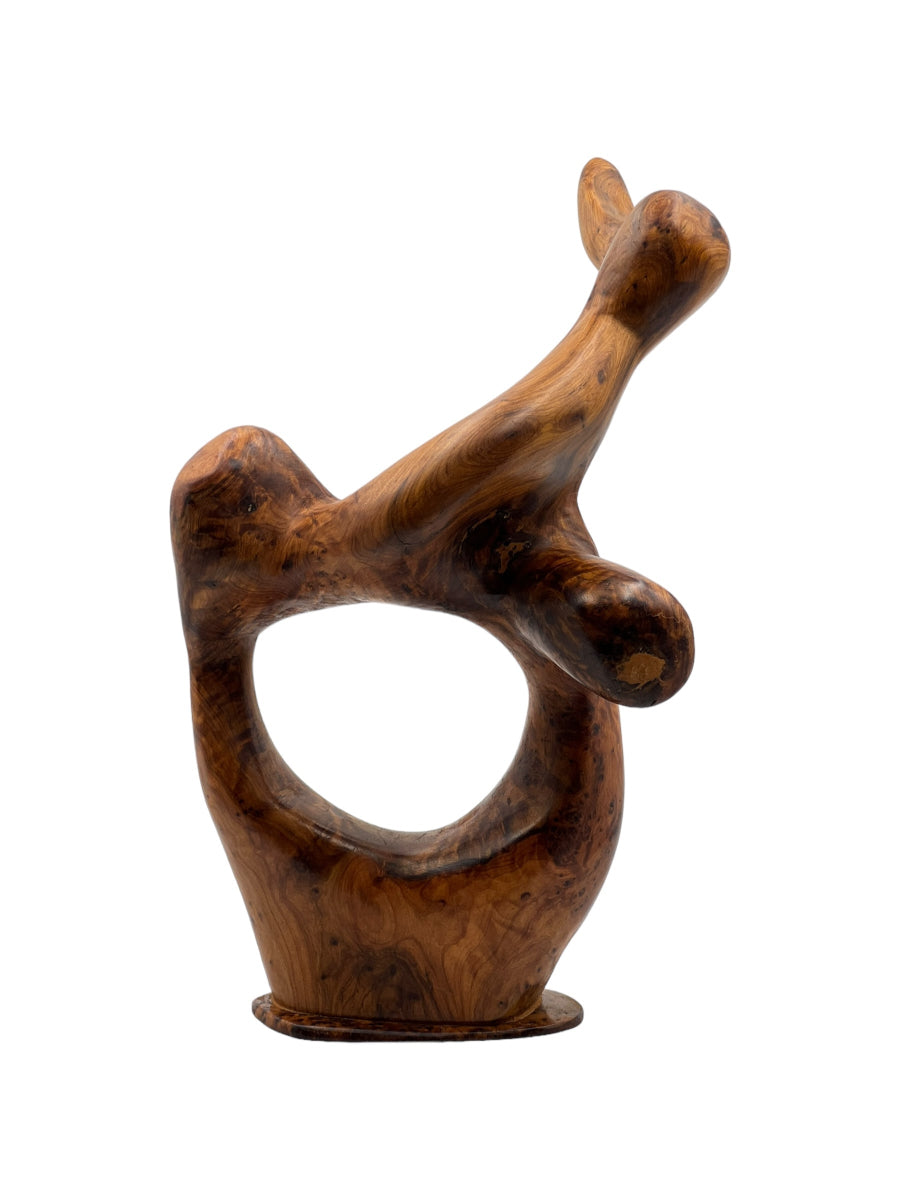 A brown wooden sculpture of an abstract figure, part of the 3ar3ar Collection.