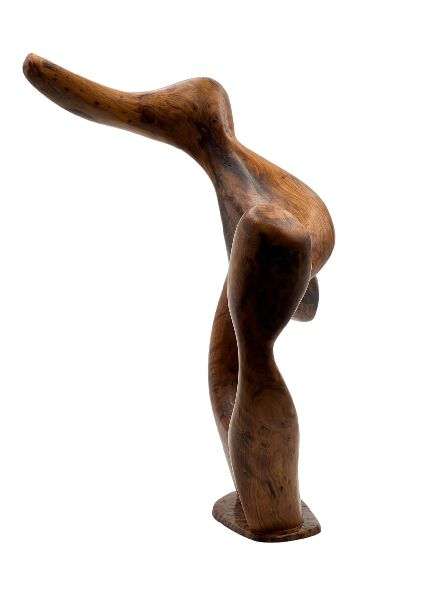 Wooden sculpture of a abstract form on a white background