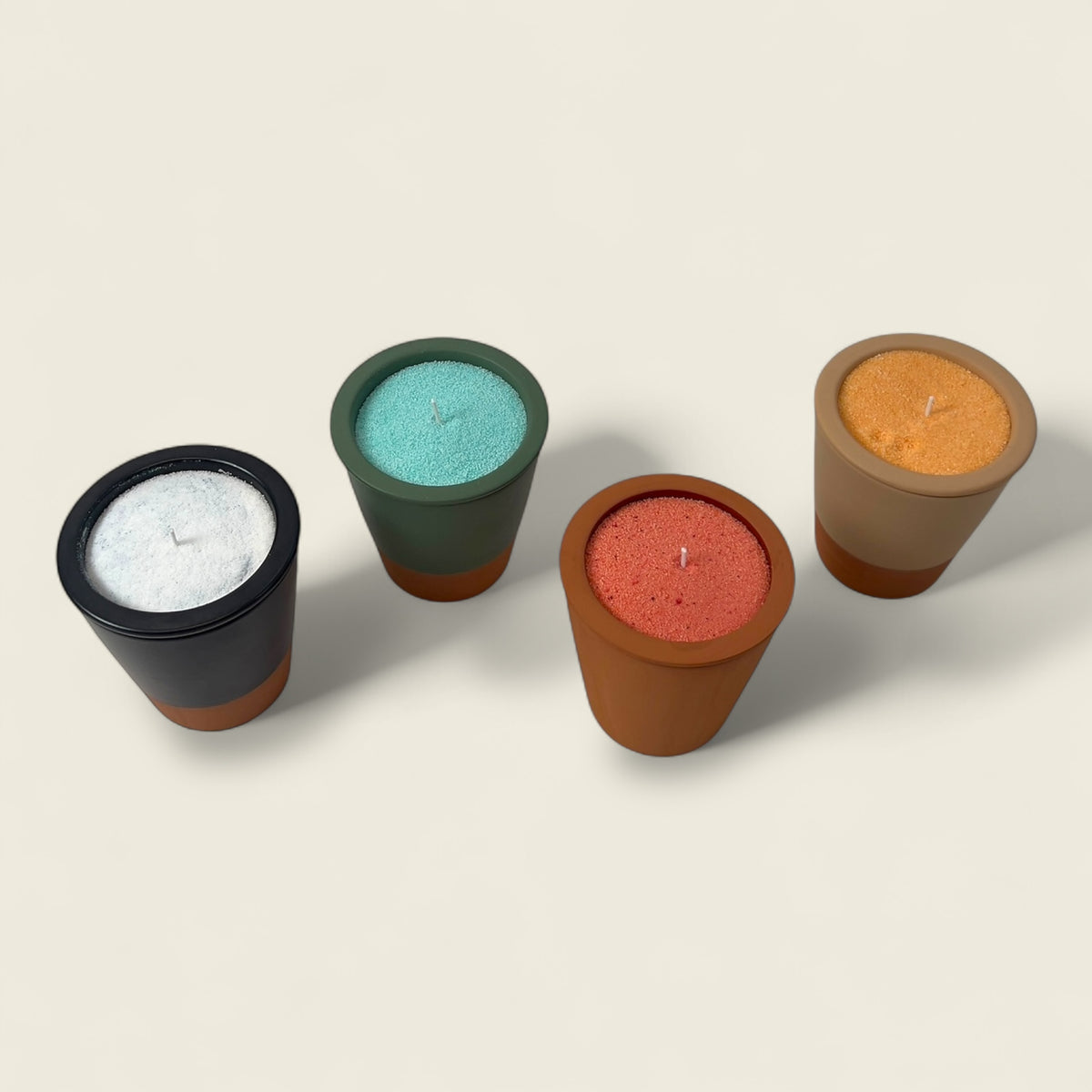 Elevate your space with Dary Living’s handcrafted clay candle pots — available in Olive Green, Ivory Cream, Matte Black, and Raw Terracotta finishes. Each artisanal vessel is Elevate your space with Dary Living’s handcrafted clay candle pots — available in Olive Green, Ivory Cream, Matte Black, and Raw Terracotta finishes. Each artisanal vessel is skillfully shaped in Marrakesh using organic red clay, then filled with richly pigmented sand wax in Orange, Green, Red, and White. The pots are designed for mult