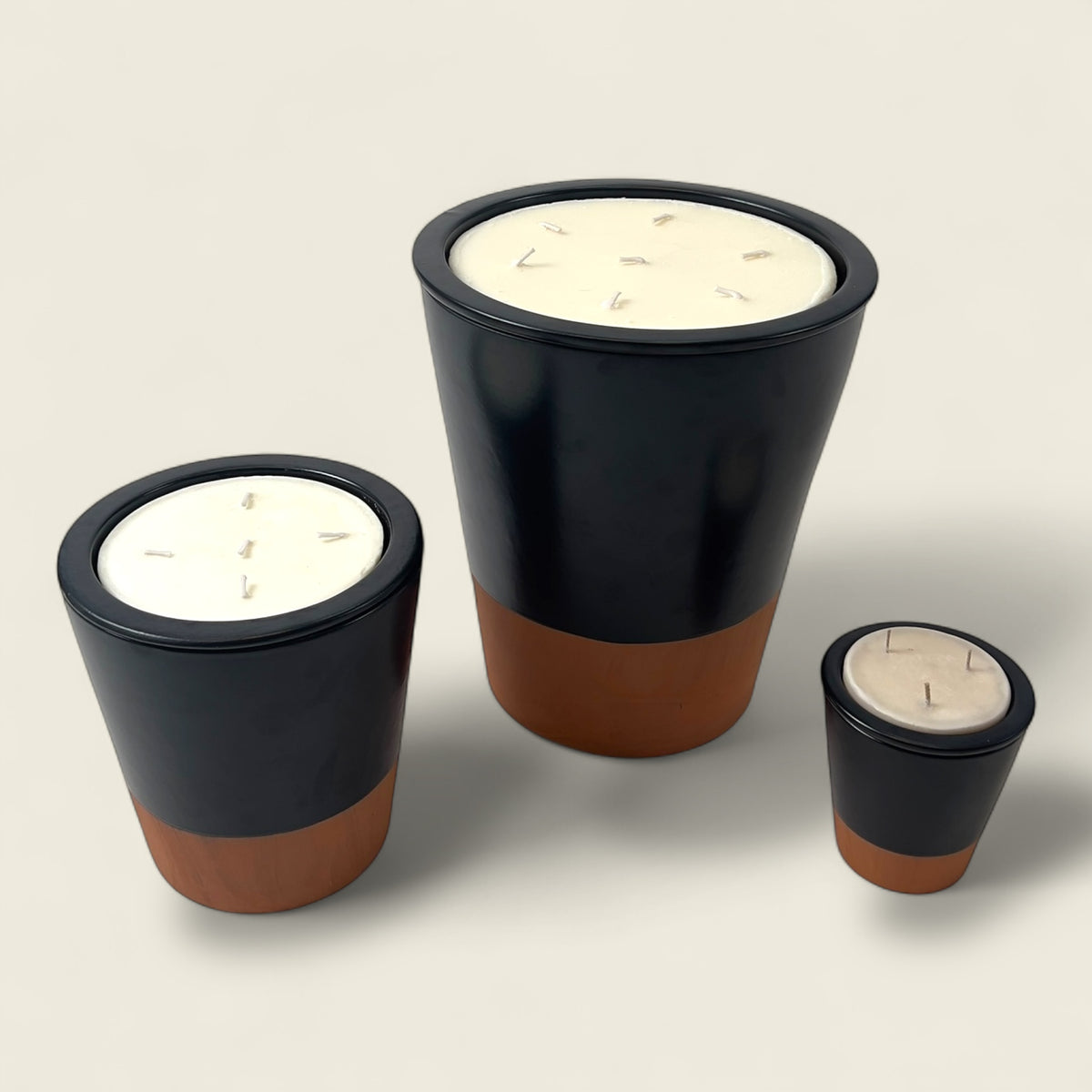 Introducing the Nora Noir Moroccan Candle — a bold fusion of tradition and elegance. Housed in handmade Moroccan clay pots available in small, medium, and large sizes, each piece is sculpted in Marrakesh using organic red clay and finished in matte black or raw terracotta. The Nora Noir collection speaks to understated luxury, where artisanal craftsmanship, natural materials, and timeless design meet. Filled with eco-conscious sand wax, these vessels radiate warmth and ambiance — perfect for elevated interi