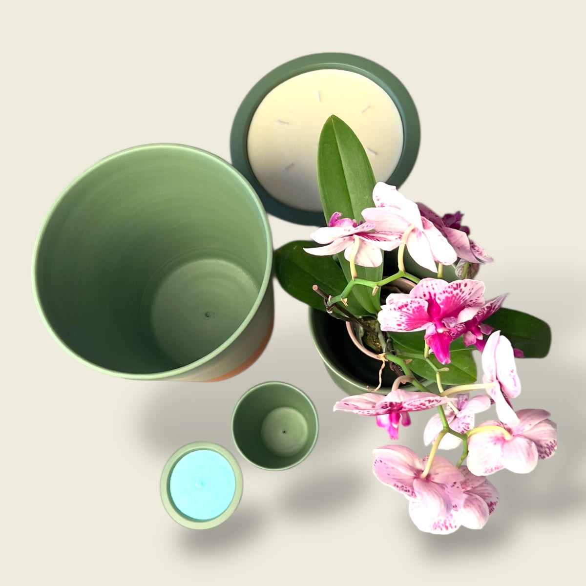 Nora Vert Moroccan Candle Set. Elevate your space with the Nora Vert Moroccan Candle Set—featuring vibrant green, hand-painted clay pots inspired by traditional Moroccan artistry. These artisan vessels bring a natural, earthy charm to any room, beautifully complementing the soft, warm glow of our premium sand wax candles. Ideal as a centerpiece or a thoughtful gift, this set adds a touch of elegance, tradition, and tranquility to your décor.